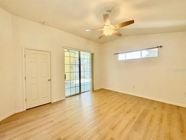 a view of an empty room with wooden floor
