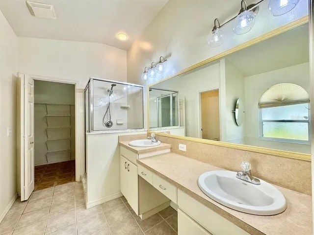 a bathroom with a sink double vanity and a mirror
