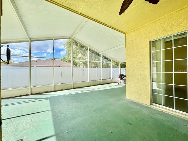 a view of a porch with furniture and a backyard