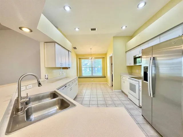 a kitchen with a sink and refrigerator