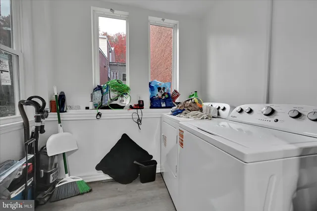 a bedroom with a bed and a flat tv screen on a dresser