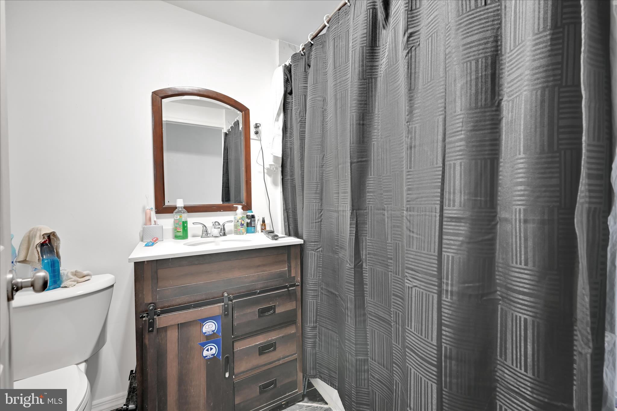 535 East Centre Street Mahanoy City, PA 17948 - Photo 16 of 26 a bathroom with a sink a toilet and a mirror
