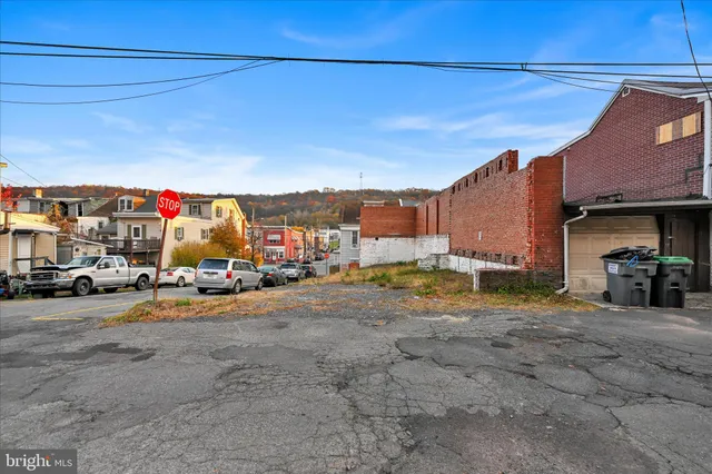 a view of a yard with an tree and a wooden fence