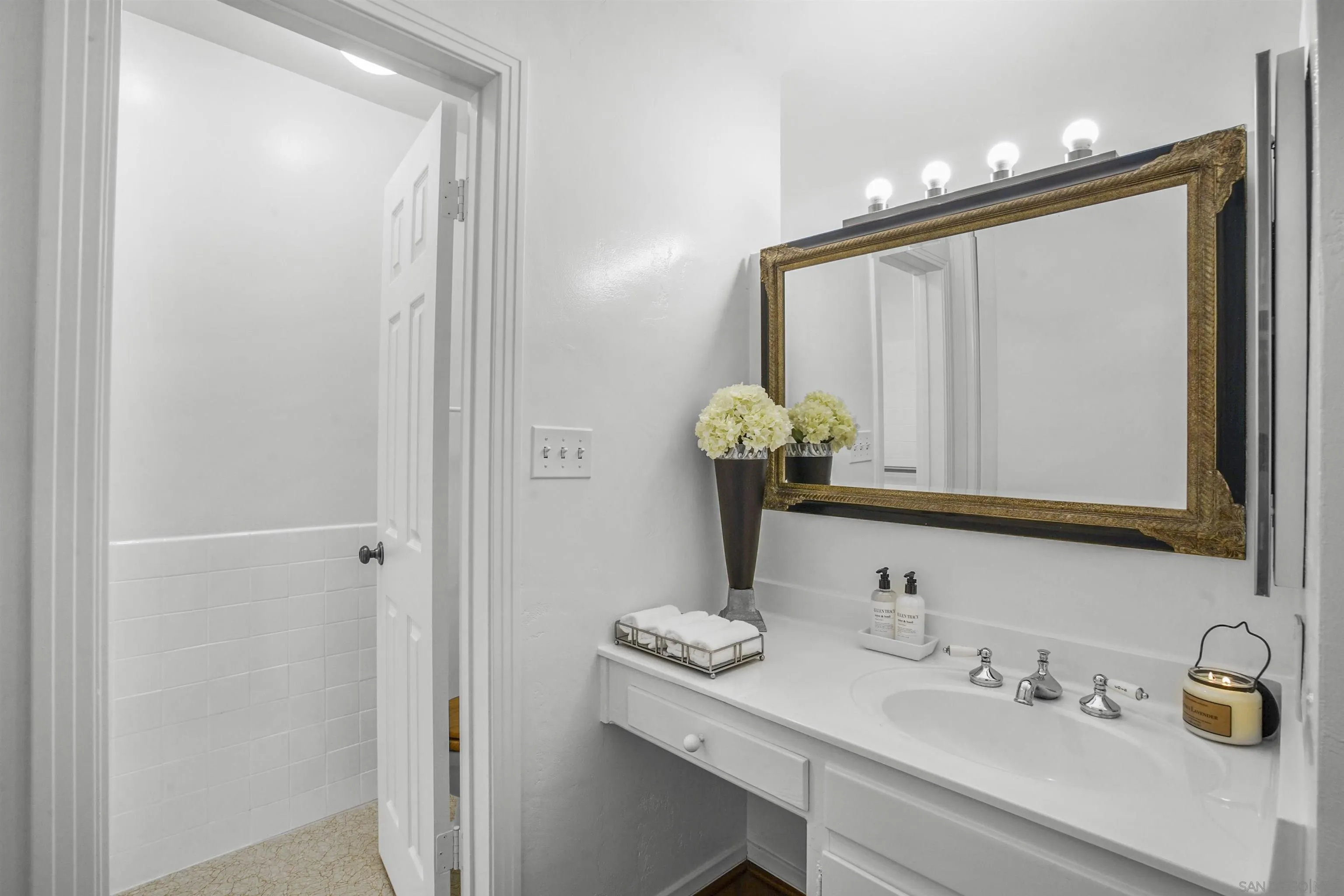 734 E Avenue Coronado, CA 92118 - Photo 16 of 30 a bathroom with a sink and a mirror