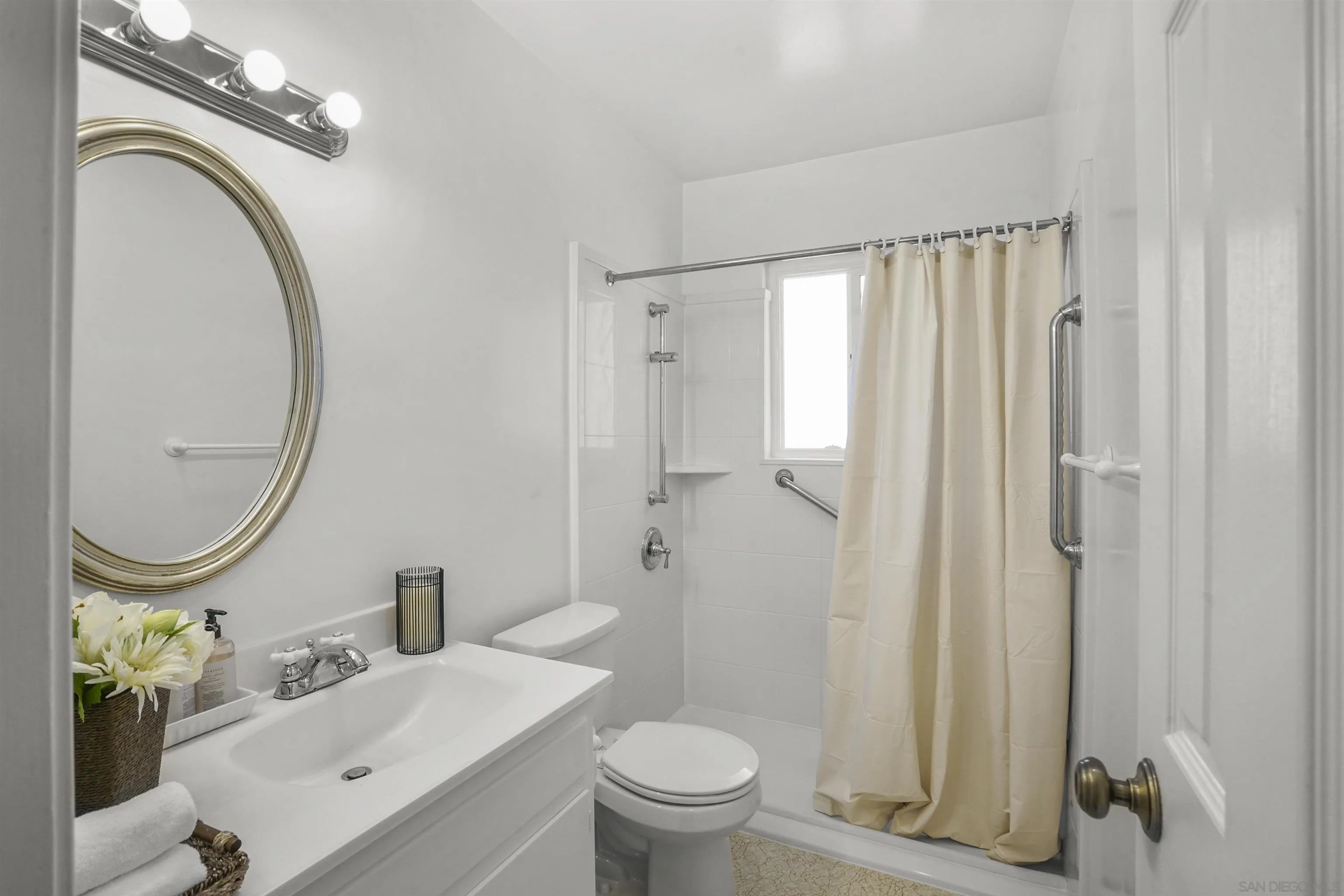 734 E Avenue Coronado, CA 92118 - Photo 17 of 30 a bathroom with a sink a toilet and a mirror