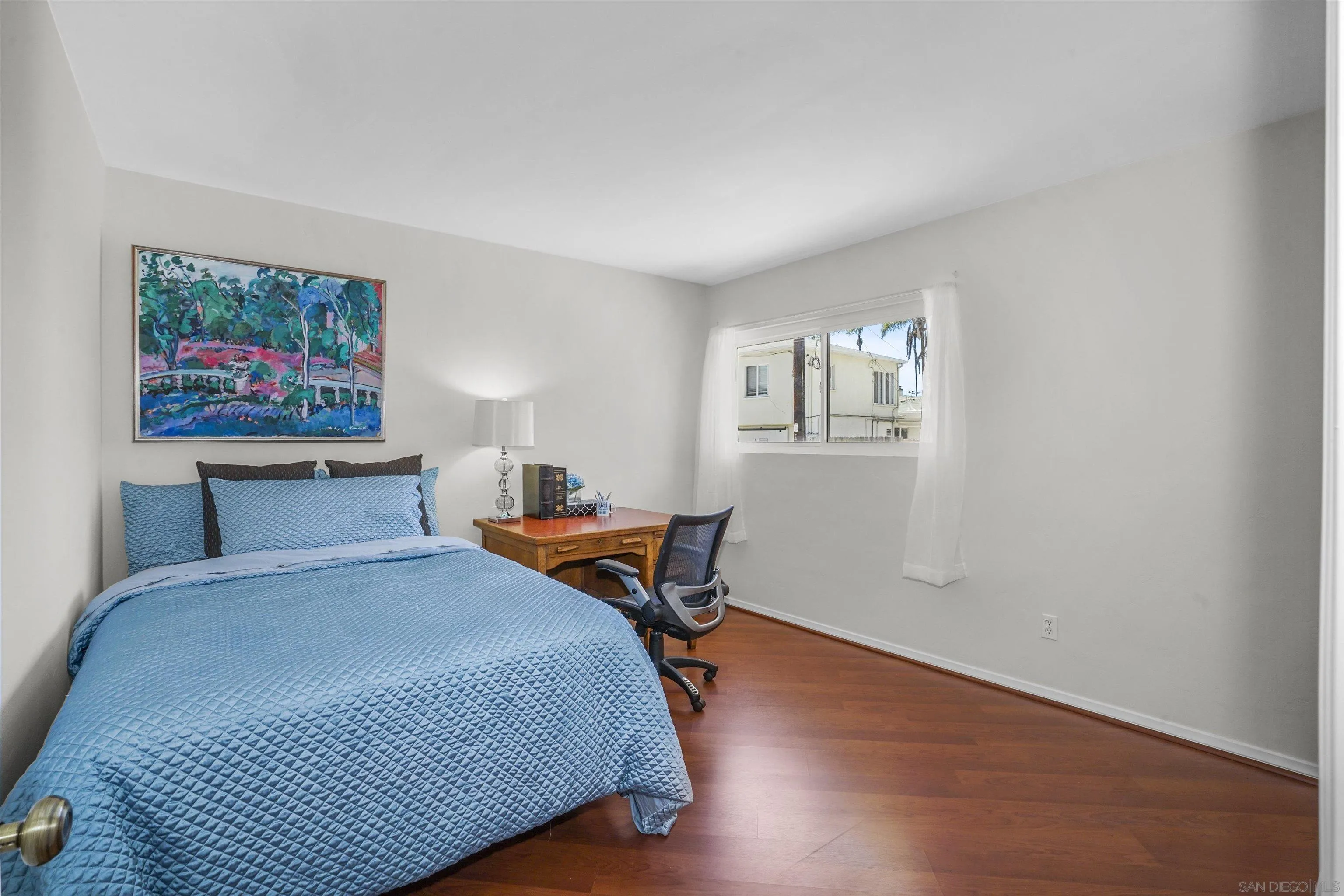 734 E Avenue Coronado, CA 92118 - Photo 19 of 30 a bedroom with a bed and a painting on the wall