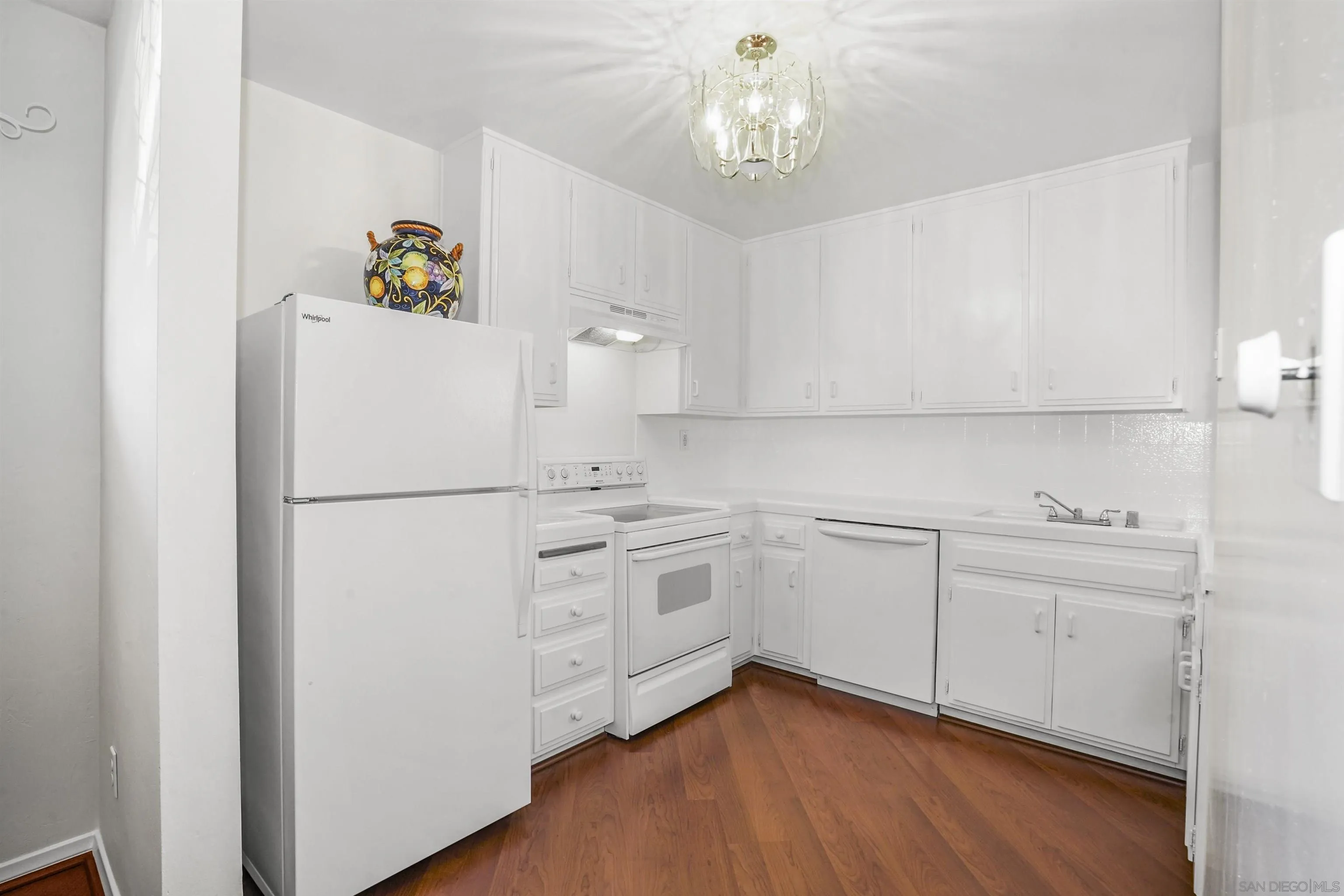734 E Avenue Coronado, CA 92118 - Photo 7 of 30 a kitchen with white cabinets and white appliances