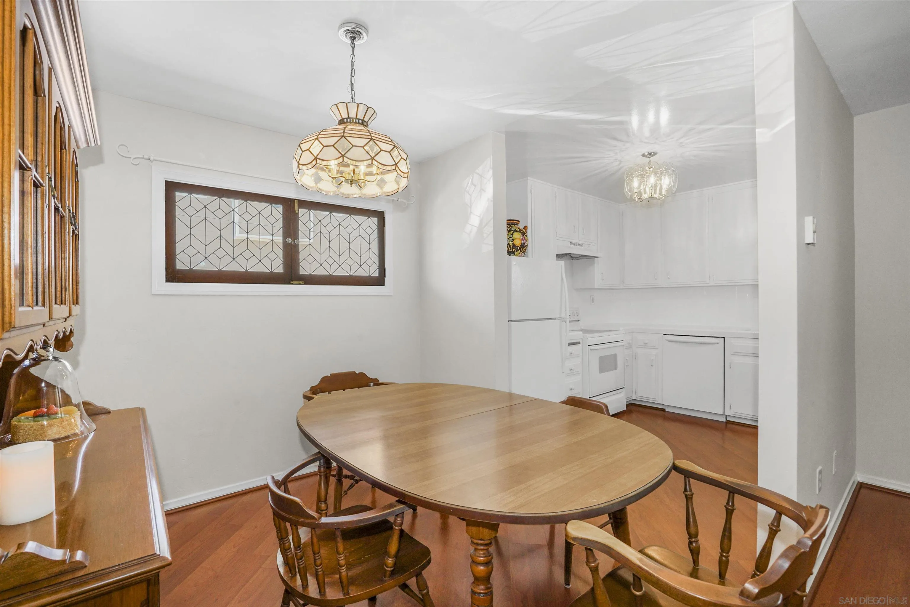 734 E Avenue Coronado, CA 92118 - Photo 10 of 30 a view of a dining room with furniture and wooden floor