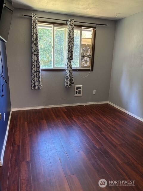 9735 Littlerock Road Southwest Olympia, WA 98512 - Photo 11 of 30 an empty room with wooden floor and windows