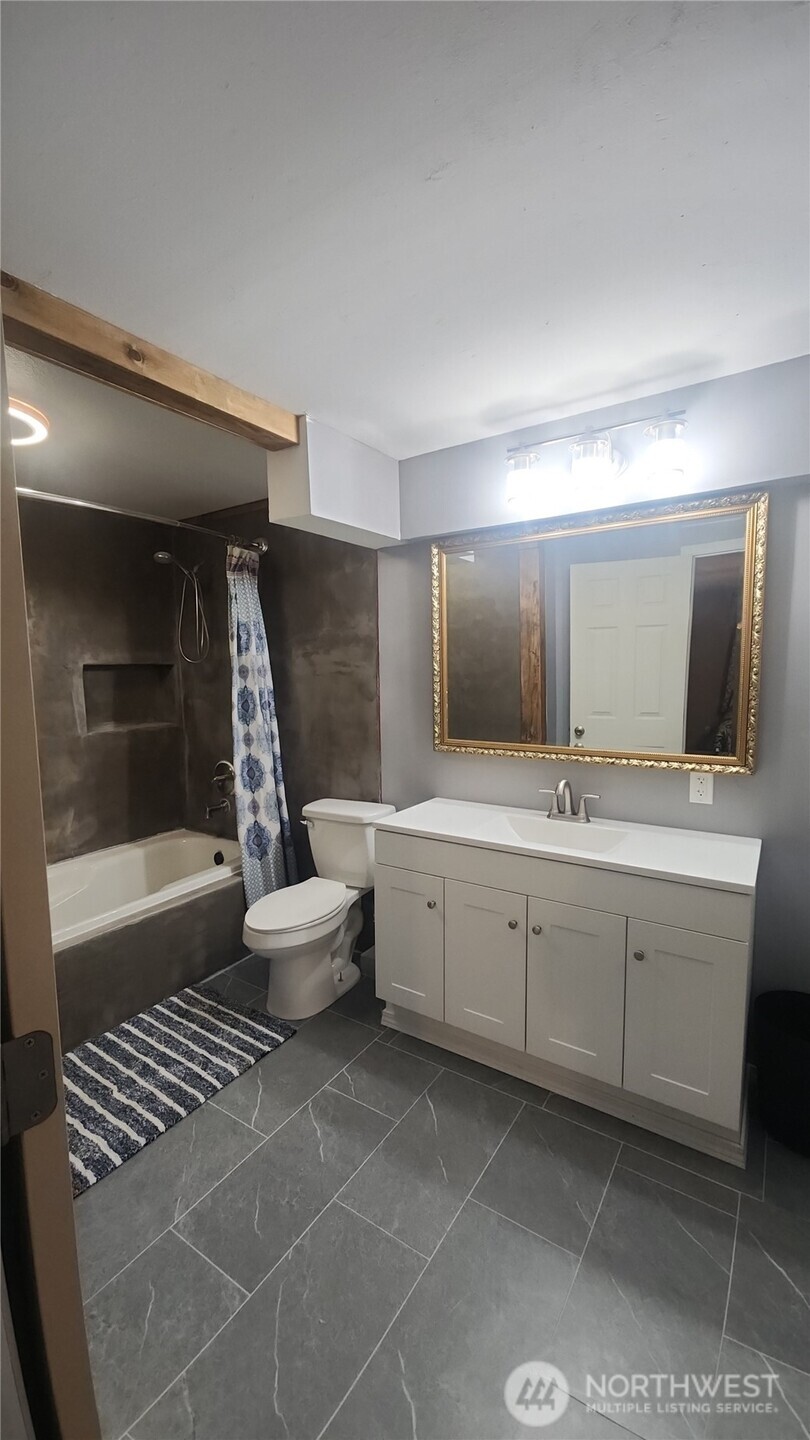 9735 Littlerock Road Southwest Olympia, WA 98512 - Photo 15 of 30 a bathroom with a double vanity sink toilet and shower