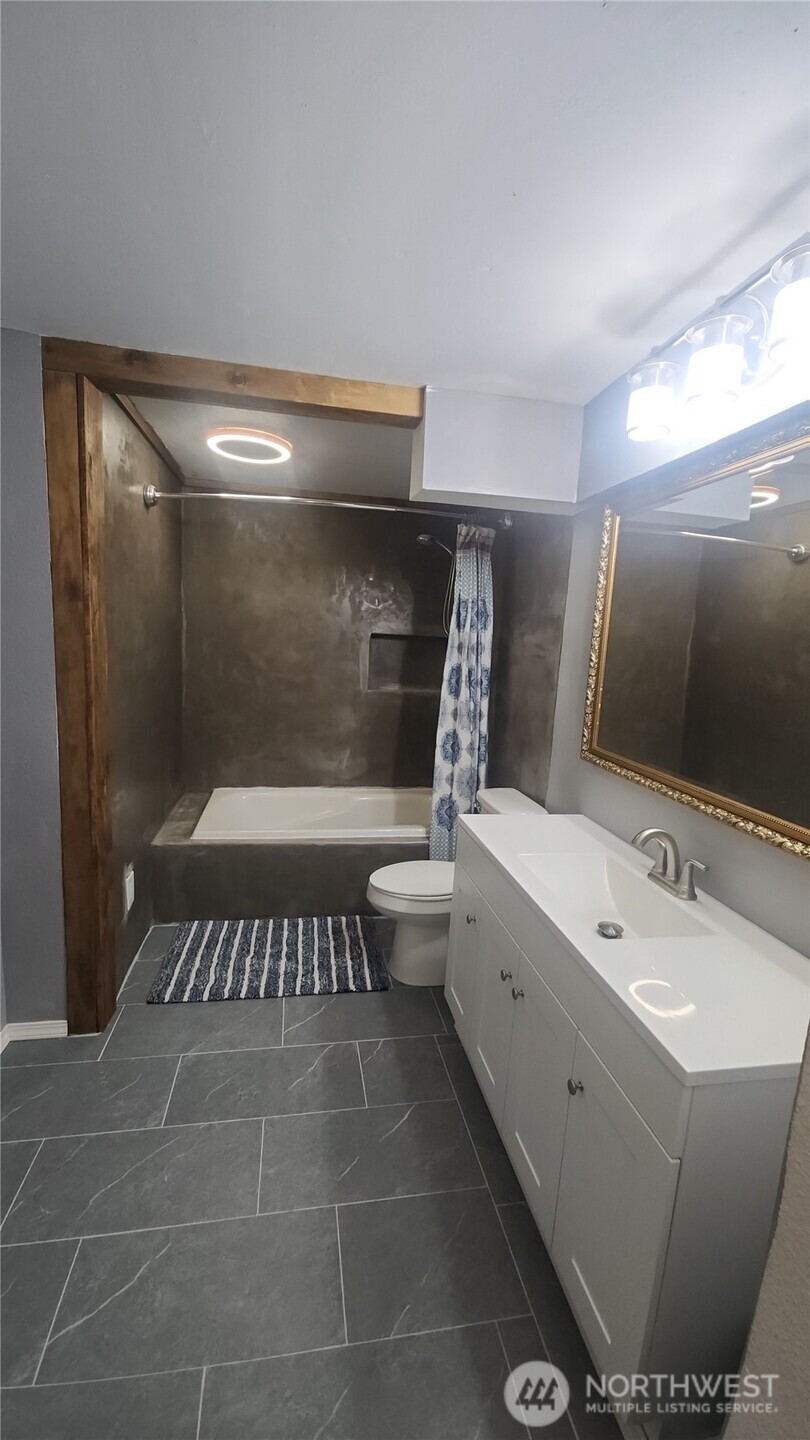 9735 Littlerock Road Southwest Olympia, WA 98512 - Photo 16 of 30 a bathroom with a bathtub and a sink