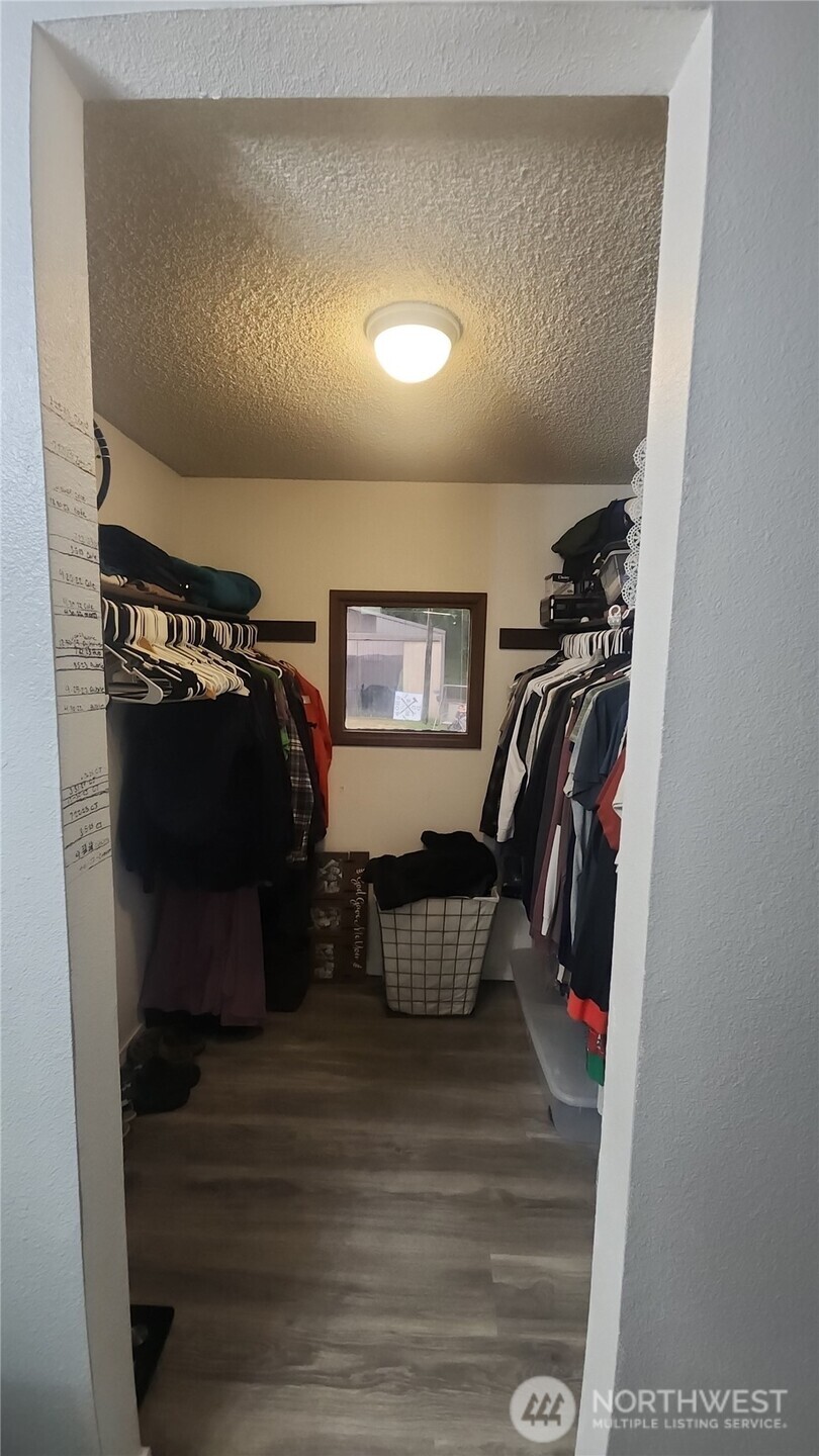 9735 Littlerock Road Southwest Olympia, WA 98512 - Photo 17 of 30 a view of walk in closet with clothes and shoes