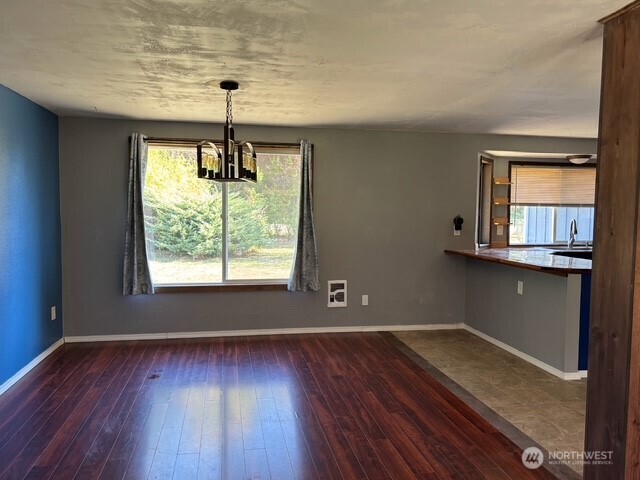 9735 Littlerock Road Southwest Olympia, WA 98512 - Photo 6 of 30 an empty room with wooden floor and windows