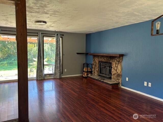 9735 Littlerock Road Southwest Olympia, WA 98512 - Photo 9 of 30 a view of an empty room with wooden floor and a window