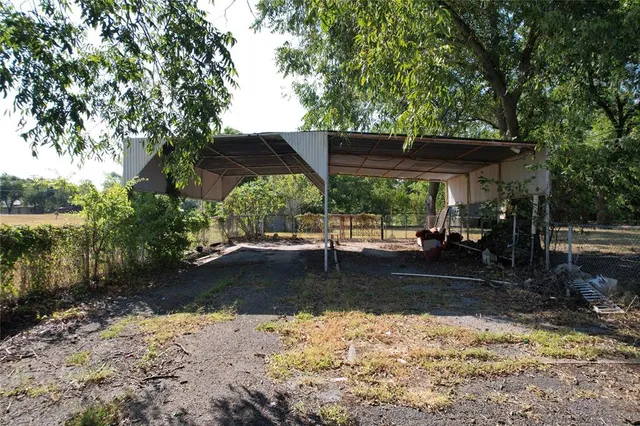 a view of a backyard with large trees