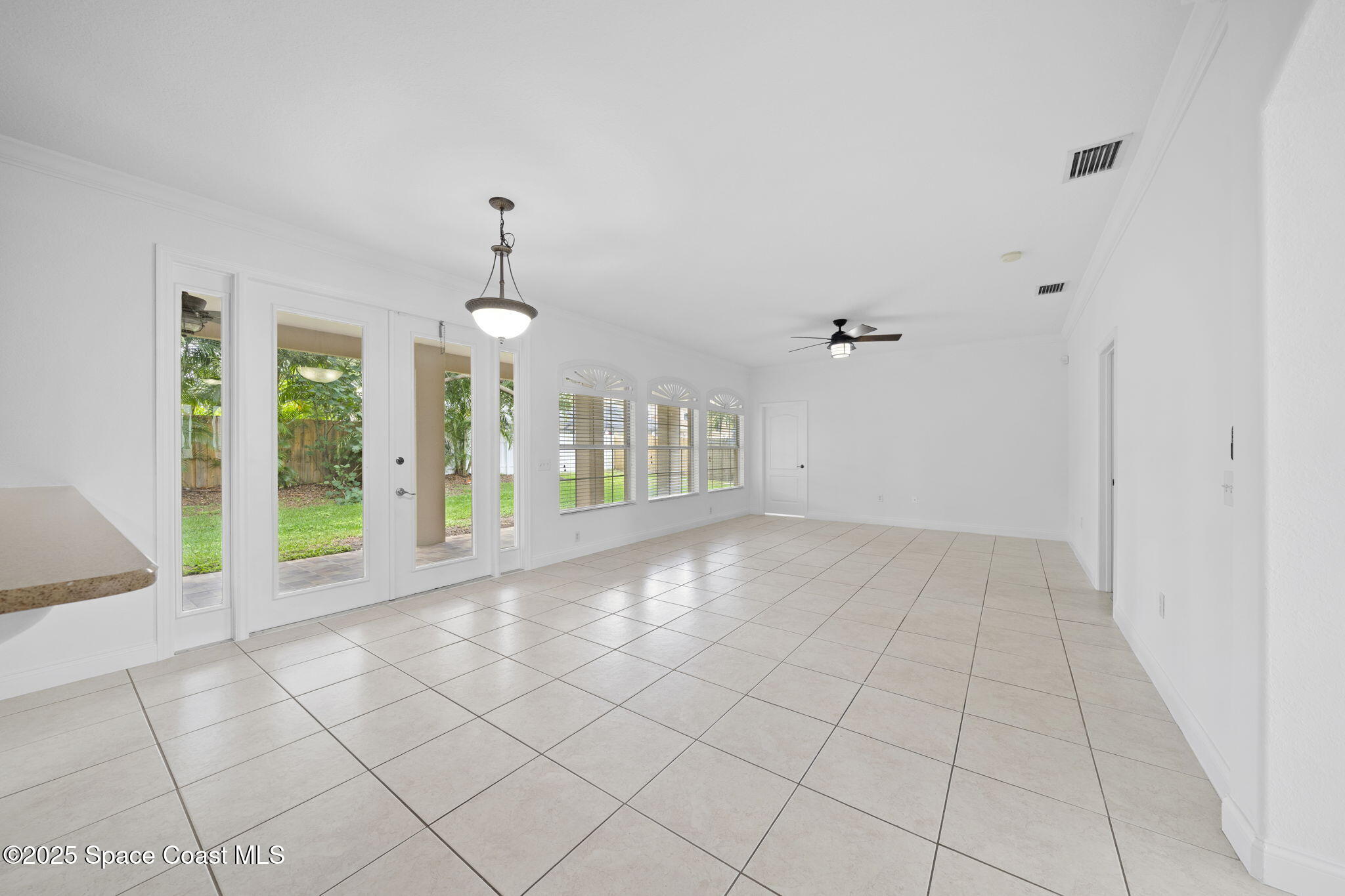 504 Glenbrook Circle Rockledge, FL 32955 - Photo 11 of 40 an empty room with entrance and windows