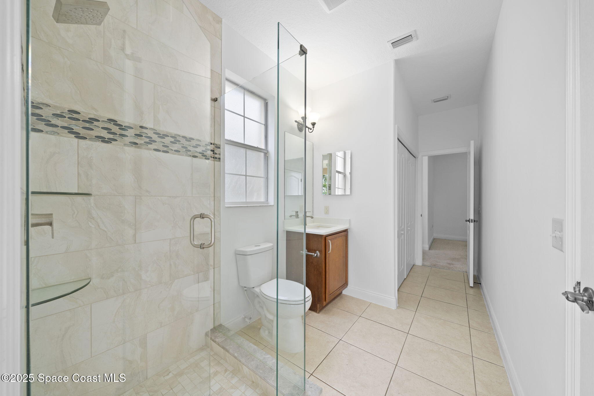 504 Glenbrook Circle Rockledge, FL 32955 - Photo 14 of 40 a bathroom with a shower and a sink