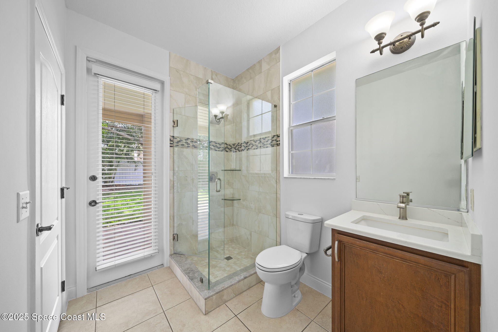 504 Glenbrook Circle Rockledge, FL 32955 - Photo 15 of 40 a bathroom with a sink a toilet and shower