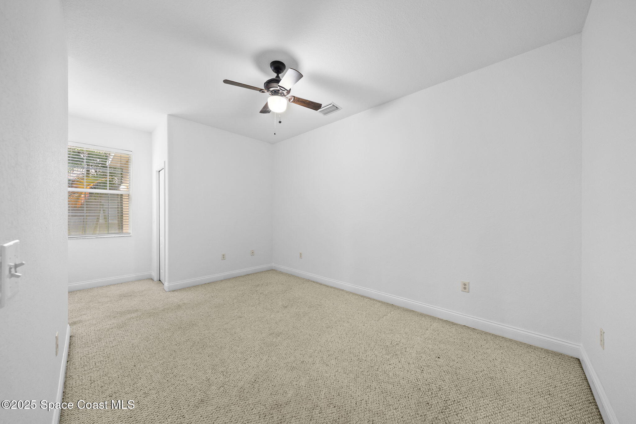 504 Glenbrook Circle Rockledge, FL 32955 - Photo 17 of 40 an empty room with windows and fan