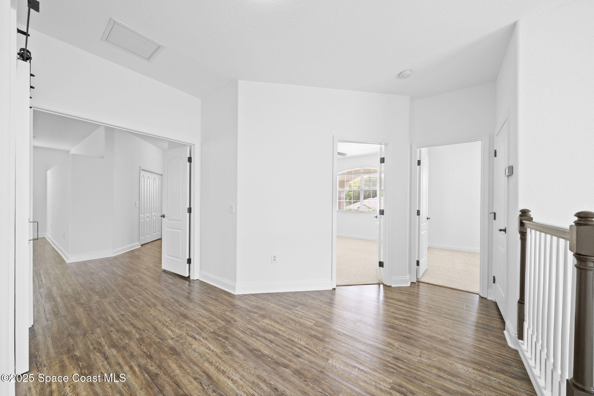 504 Glenbrook Circle Rockledge, FL 32955 - Photo 21 of 40 a view of an empty room with wooden floor