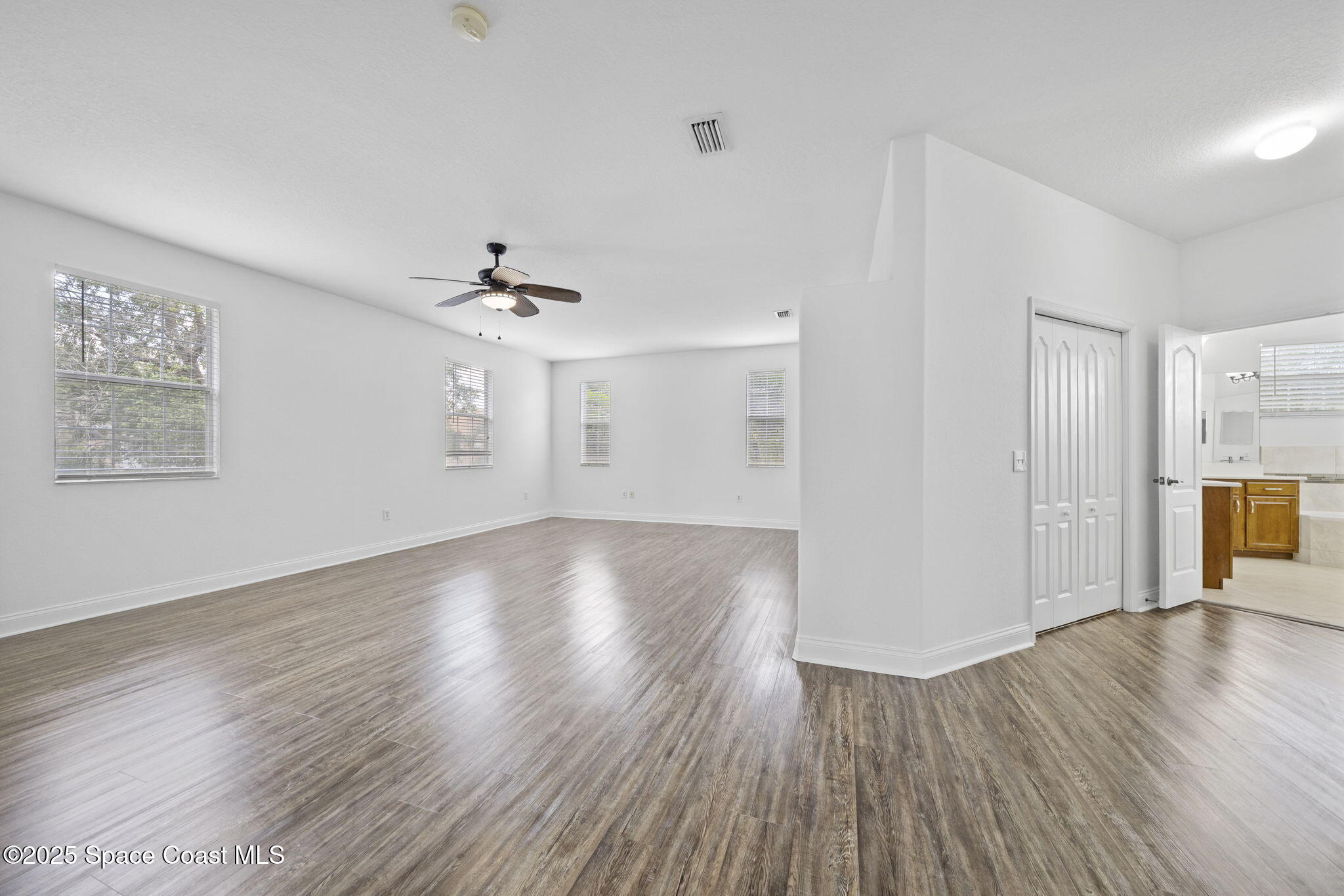 504 Glenbrook Circle Rockledge, FL 32955 - Photo 23 of 40 a view of a livingroom with wooden floor and a ceiling fan