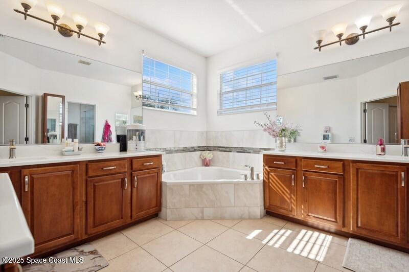 504 Glenbrook Circle Rockledge, FL 32955 - Photo 25 of 40 a spacious bathroom with a tub sink and mirror