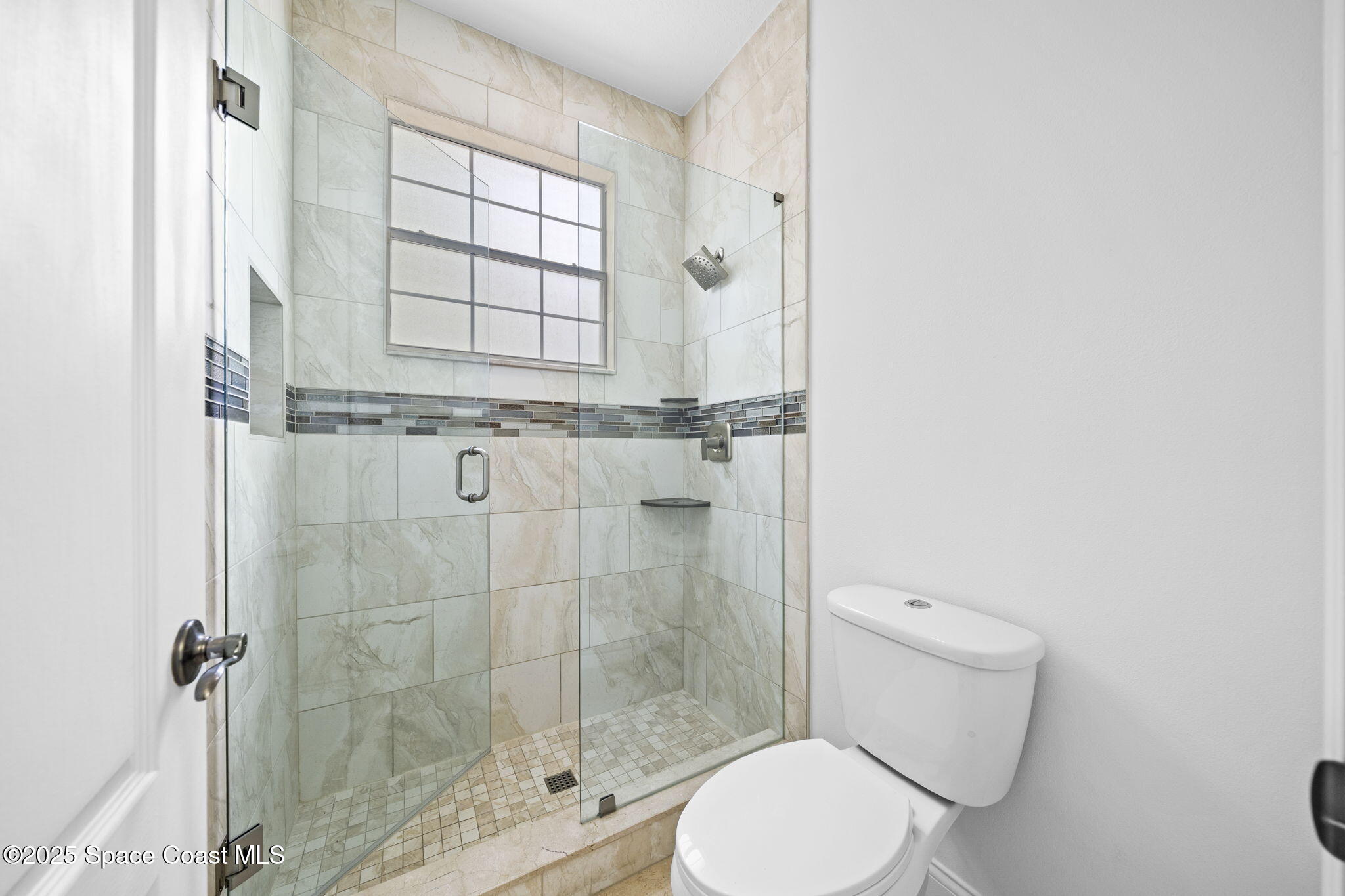 504 Glenbrook Circle Rockledge, FL 32955 - Photo 34 of 40 a white toilet next to a window