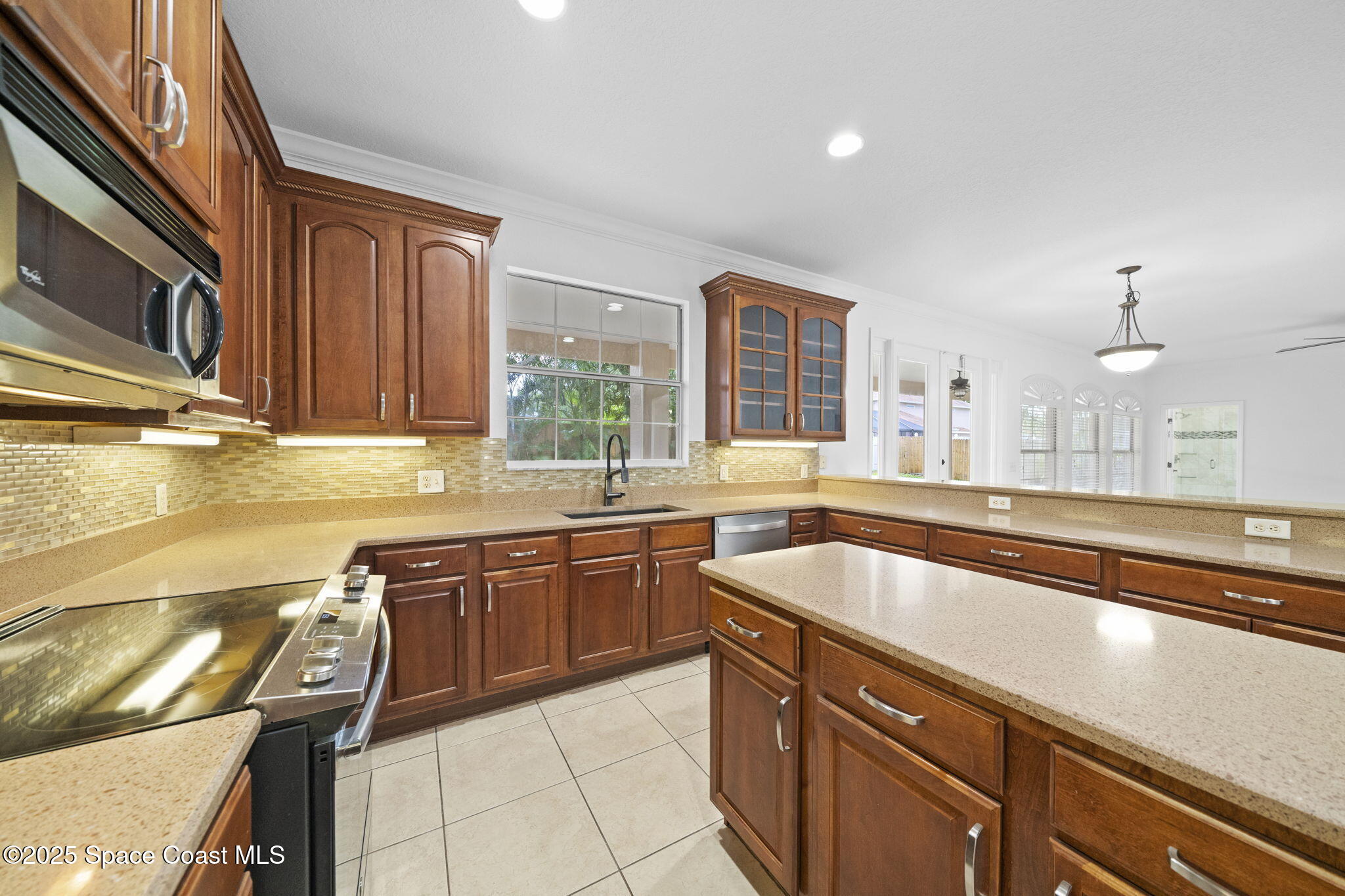 504 Glenbrook Circle Rockledge, FL 32955 - Photo 8 of 40 a kitchen with a sink and a stove top oven