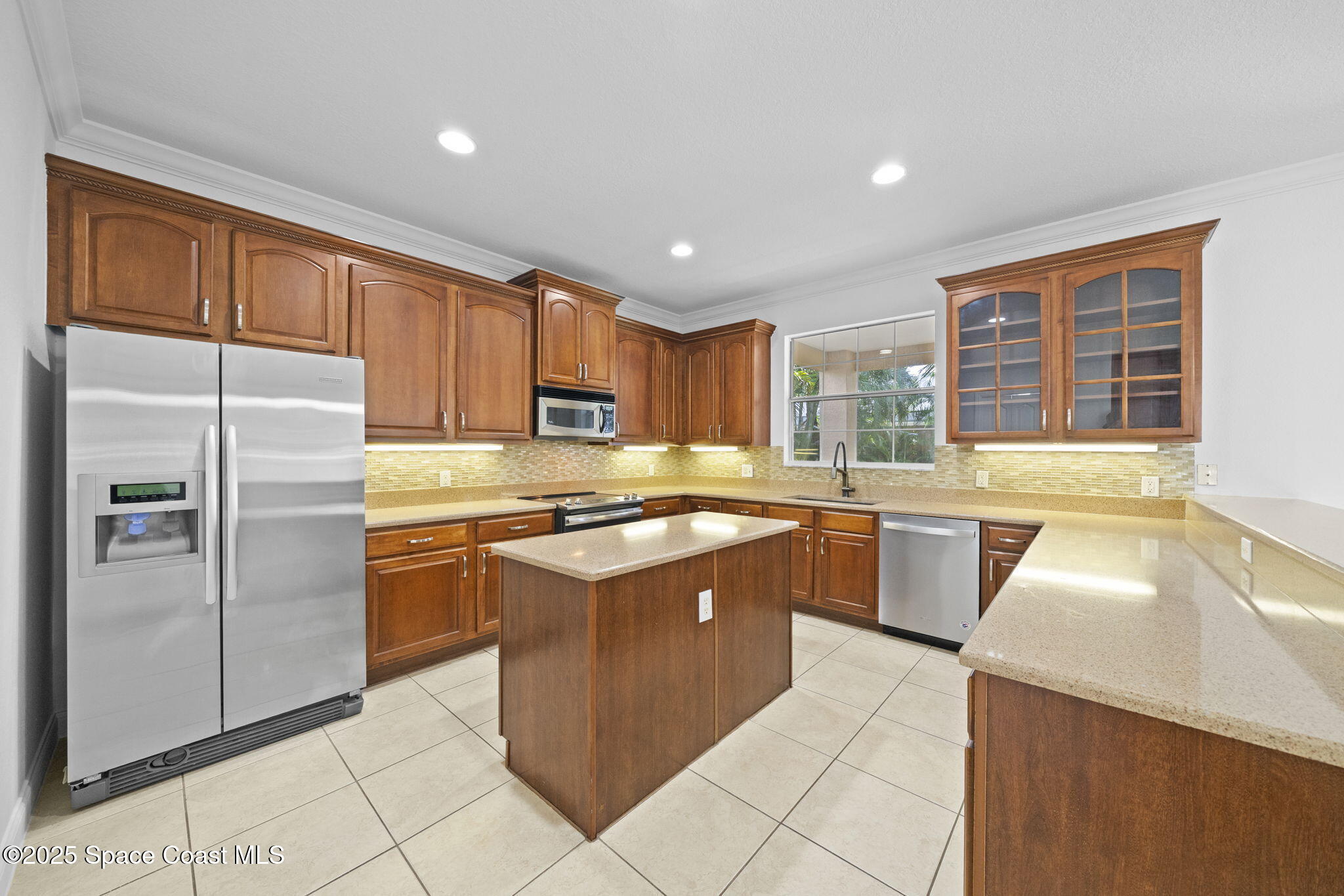 504 Glenbrook Circle Rockledge, FL 32955 - Photo 9 of 40 a kitchen with stainless steel appliances granite countertop a sink and a refrigerator