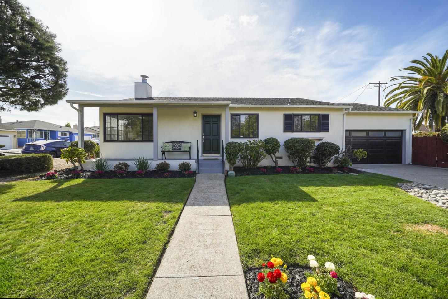 a front view of house with yard and green space