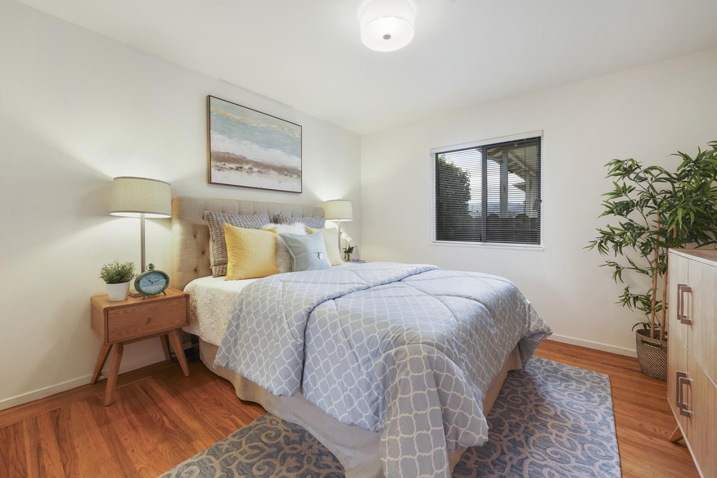 348 San Pablo Avenue Millbrae, CA 94030 - Photo 11 of 20 a bedroom with a bed and a potted plant