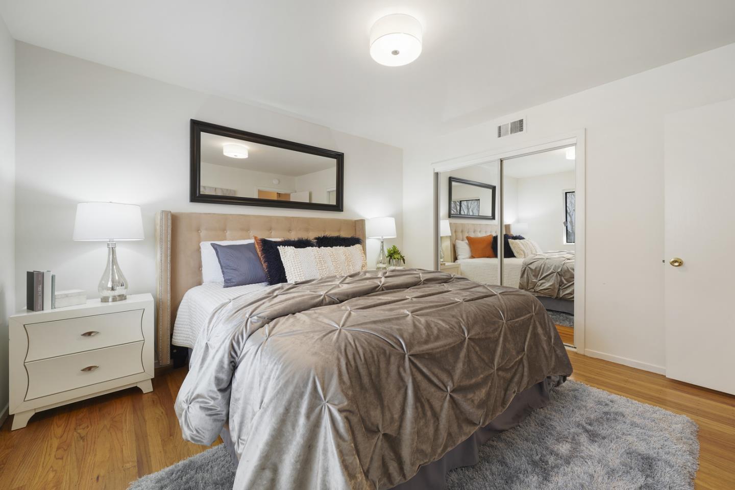 348 San Pablo Avenue Millbrae, CA 94030 - Photo 17 of 20 a bedroom with a bed and a painting on the wall