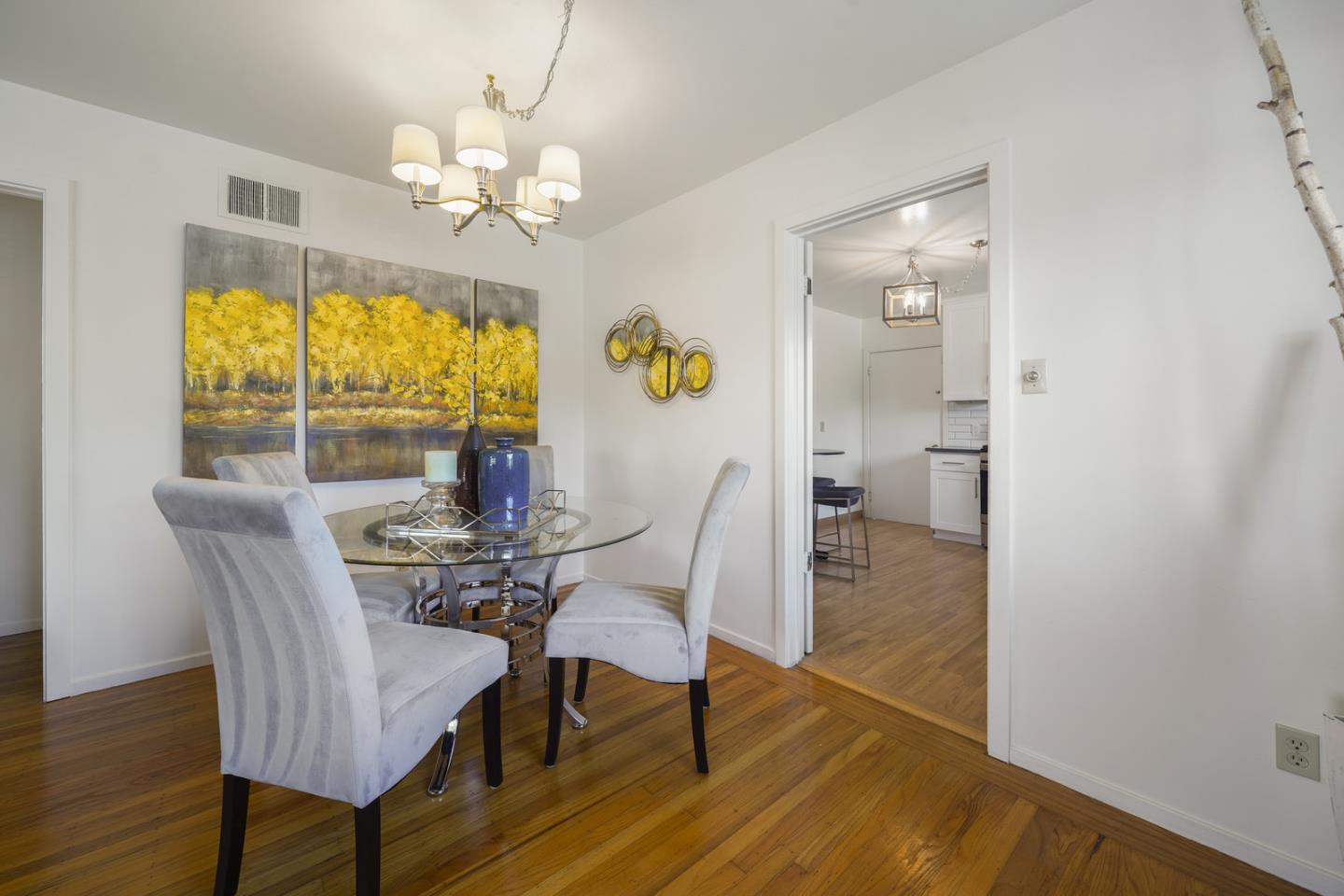348 San Pablo Avenue Millbrae, CA 94030 - Photo 8 of 20 a view of a dining room with furniture a chandelier and wooden floor