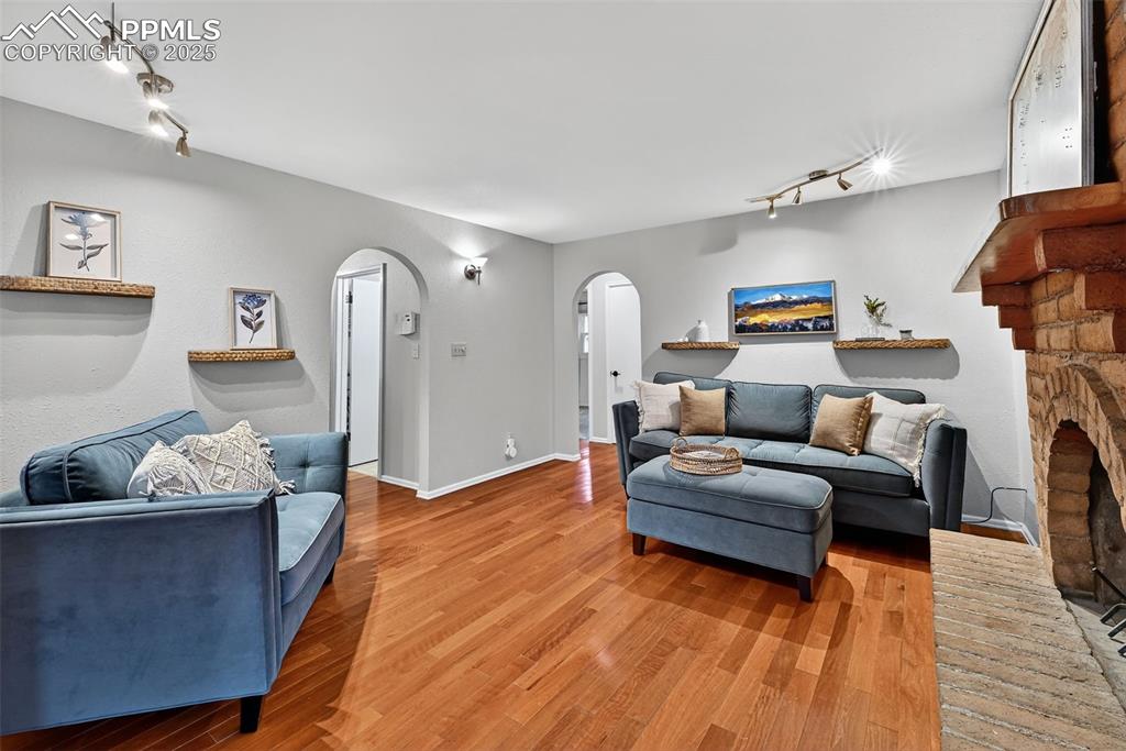 3102 Brenner Place Colorado Springs, CO 80917 - Photo 11 of 38 a living room with furniture and a wooden floor