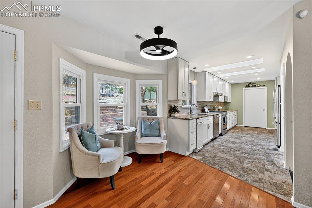 3102 Brenner Place Colorado Springs, CO 80917 - Photo 14 of 38 a living room with furniture and a chandelier