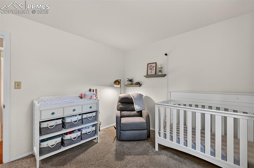 3102 Brenner Place Colorado Springs, CO 80917 - Photo 21 of 38 a bedroom with furniture and a baby crib