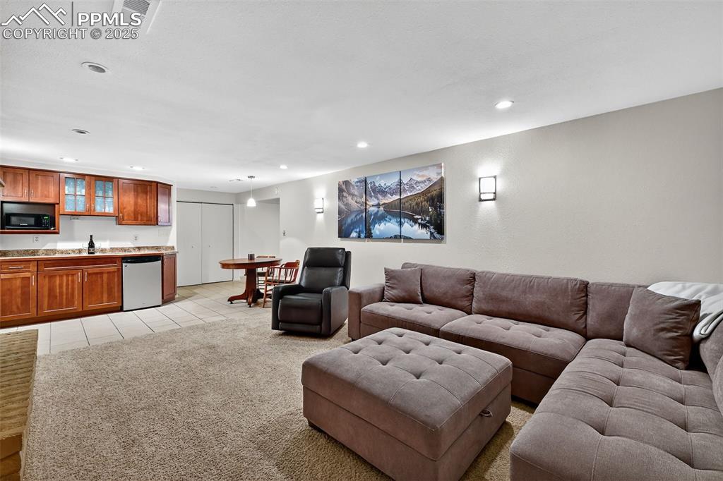 3102 Brenner Place Colorado Springs, CO 80917 - Photo 26 of 38 a living room with furniture and kitchen view