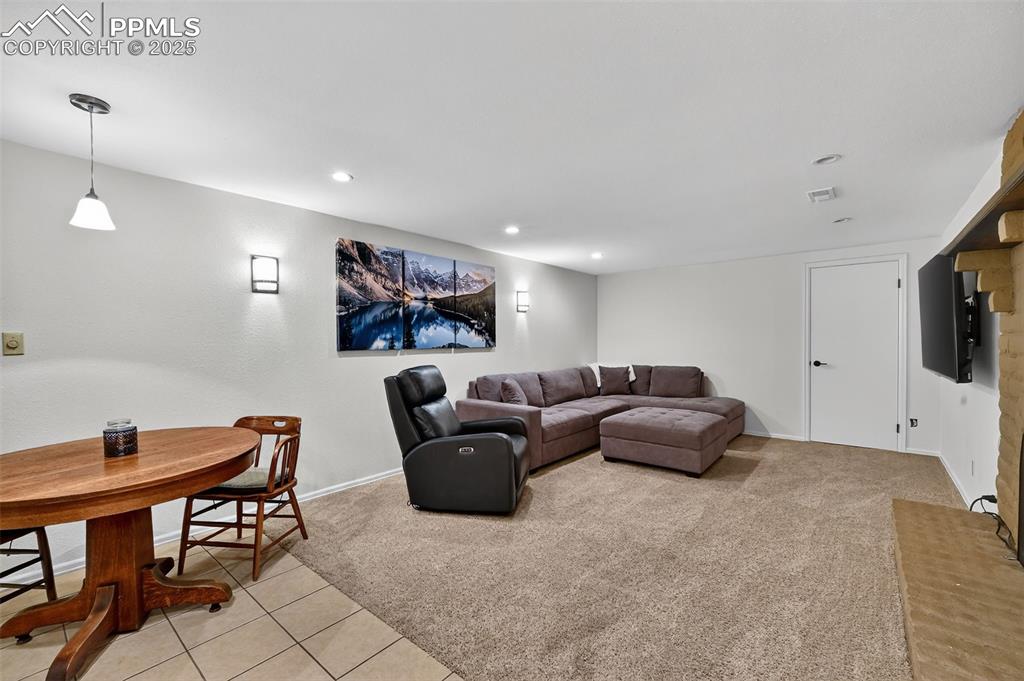 3102 Brenner Place Colorado Springs, CO 80917 - Photo 28 of 38 a living room with furniture and a flat screen tv