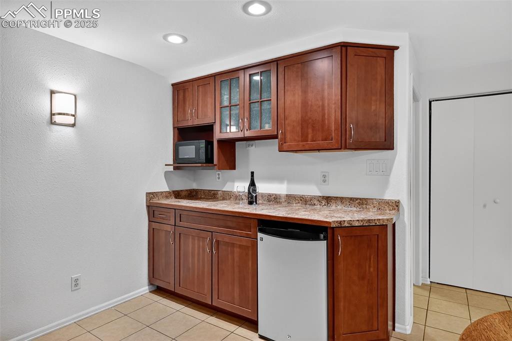 3102 Brenner Place Colorado Springs, CO 80917 - Photo 29 of 38 a kitchen with stainless steel appliances granite countertop a sink stove and cabinets