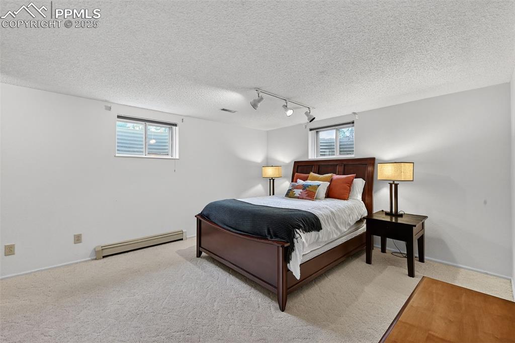 3102 Brenner Place Colorado Springs, CO 80917 - Photo 32 of 38 a bed room with a bed and a night stand