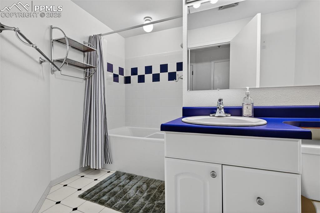 3102 Brenner Place Colorado Springs, CO 80917 - Photo 34 of 38 a bathroom with a sink and a mirror