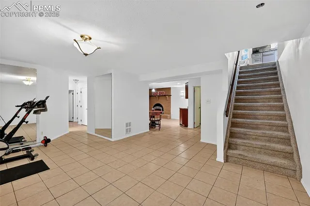 a view of a livingroom with furniture and stairs