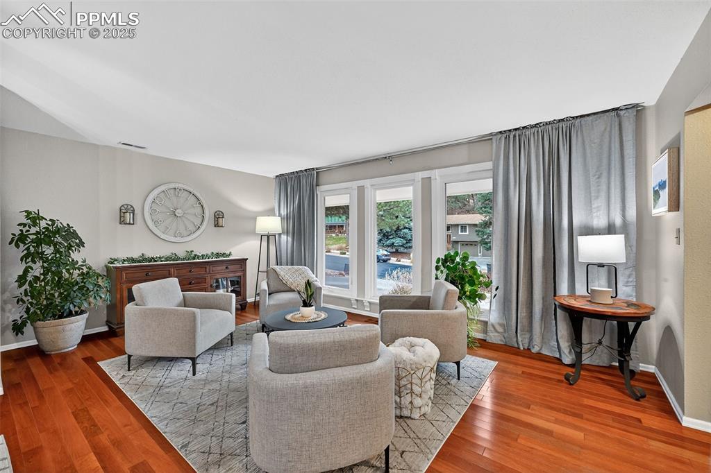 3102 Brenner Place Colorado Springs, CO 80917 - Photo 7 of 38 a living room with furniture a rug a lamp and a large window