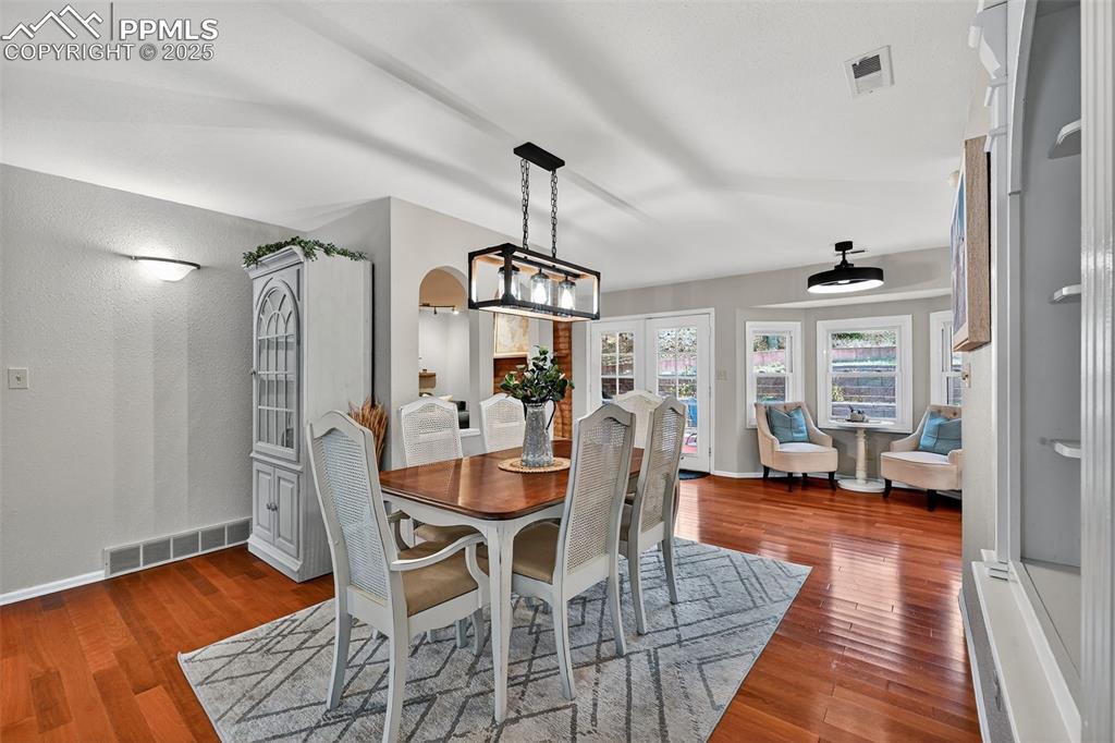 3102 Brenner Place Colorado Springs, CO 80917 - Photo 8 of 38 a view of a dining room with furniture window and wooden floor