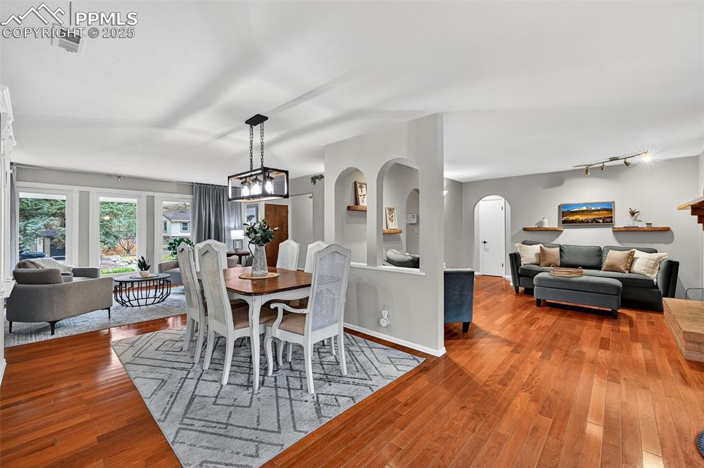 3102 Brenner Place Colorado Springs, CO 80917 - Photo 10 of 38 a living room with furniture dining table and a wooden floor
