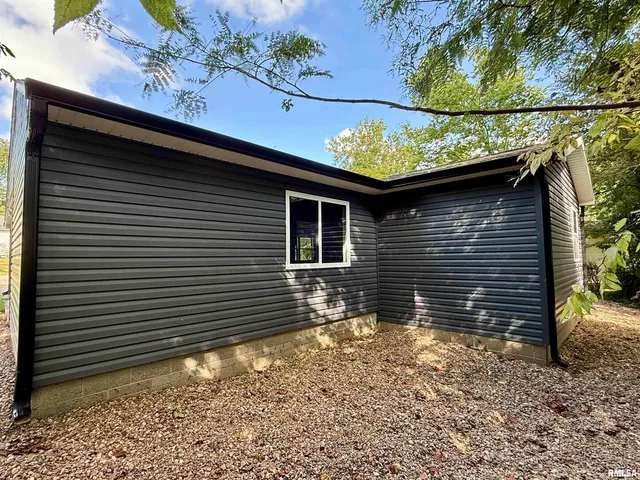 a side view of a house with a patio
