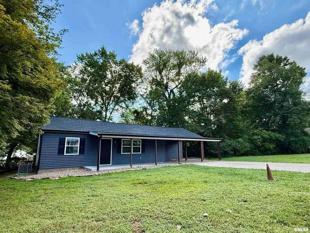 a backyard of a house with wooden floor and fence