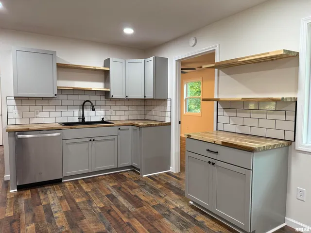 a kitchen with a sink window and cabinets