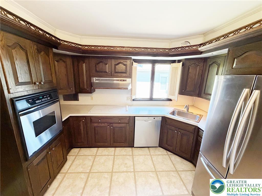 2741 Limestone Street Coplay, PA 18037 - Photo 7 of 35 a kitchen with stainless steel appliances granite countertop a sink stove and refrigerator