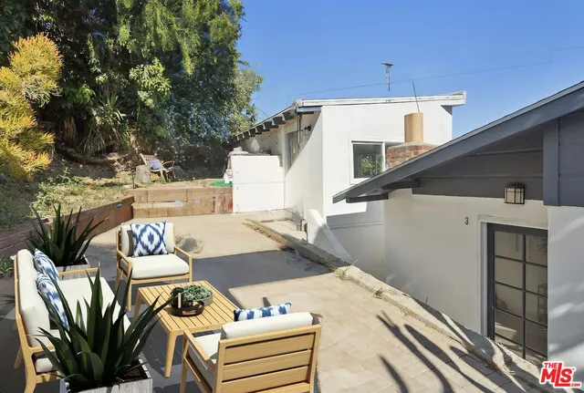 a terrace of a house with outdoor seating